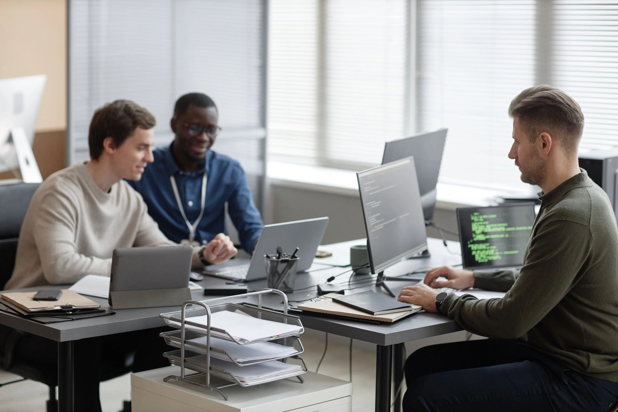 Group of IT professionals working together at desks