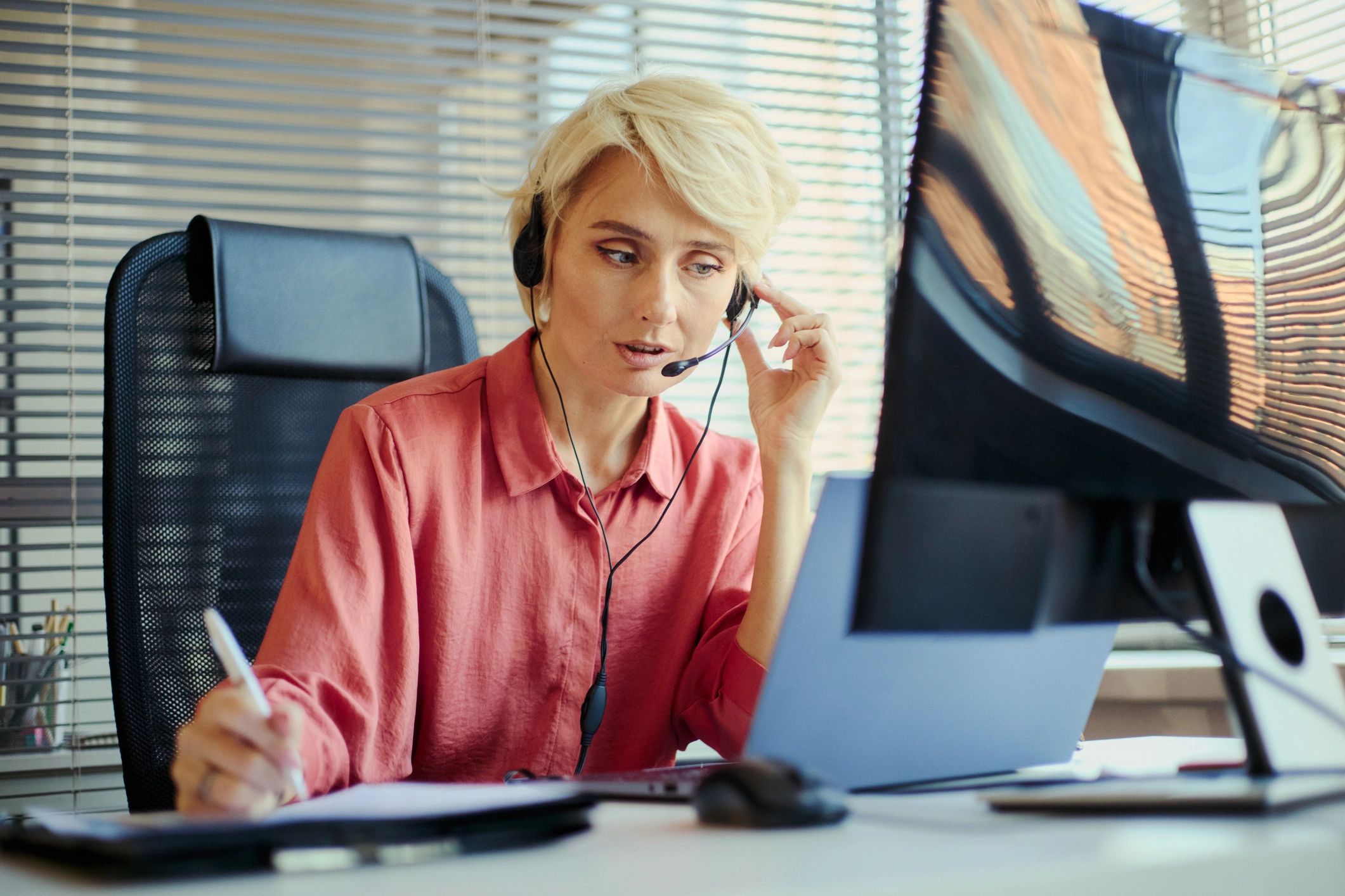 Adult Woman Working in Call Center Office and Taking Customer Notes
